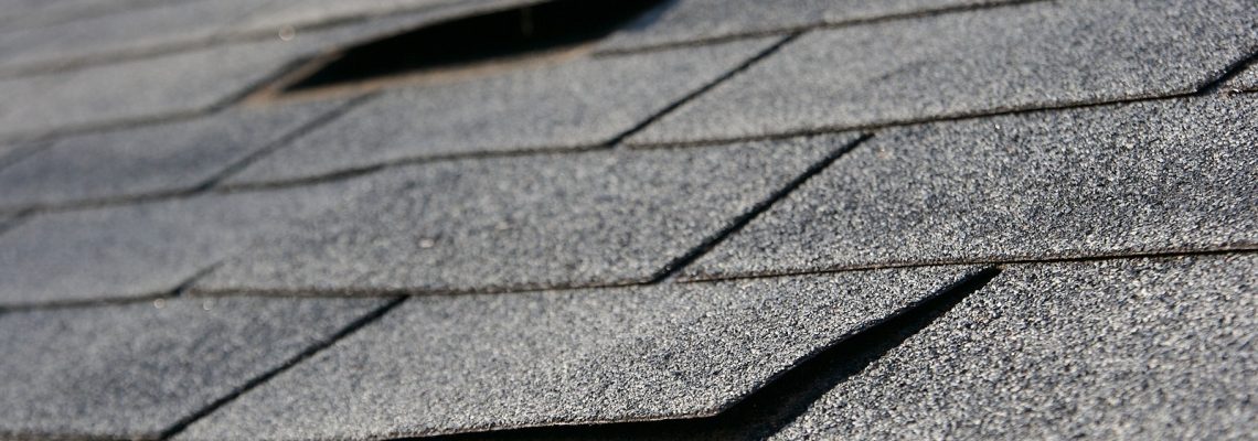 Roofing trouble - damage to shingles that needs repair - home maintenance series. Narrow DOF